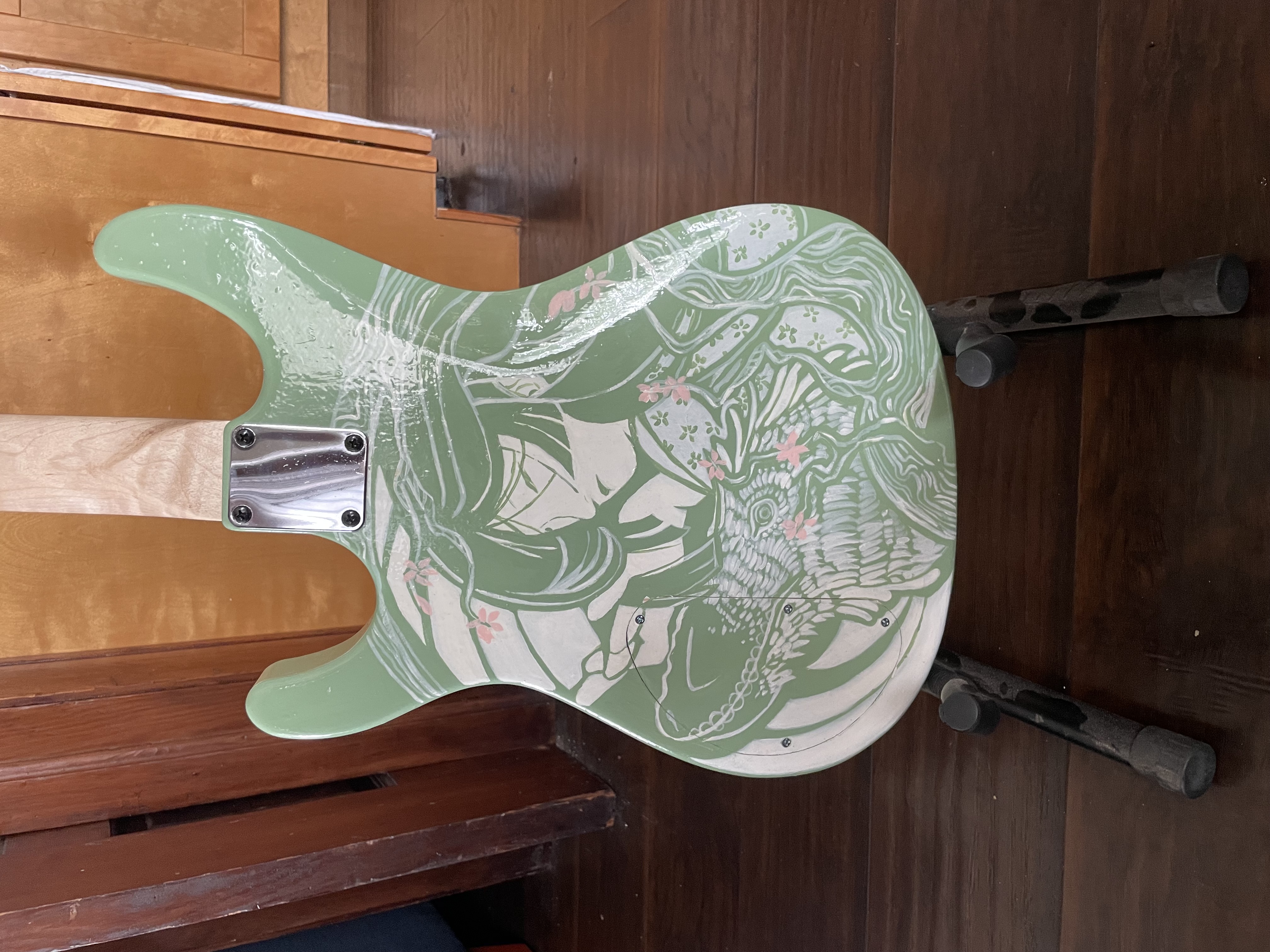 Back of green guitar <br> Wood and acrylic <br> Crafted by Andrew Aubertin. Artwork by Erika Novitsky