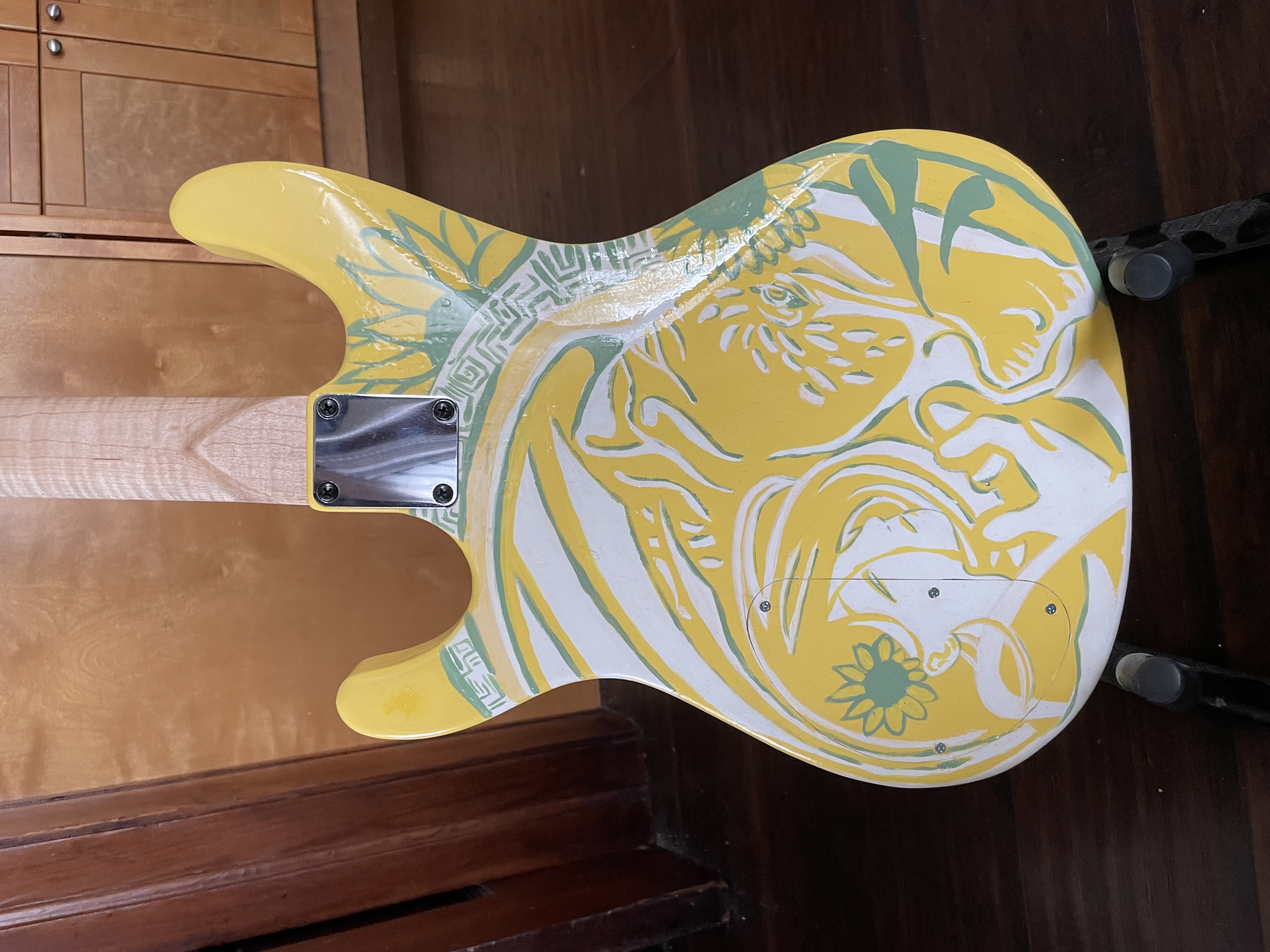Back of yellow guitar <br> Wood and acrylic <br> Crafted by Andrew Aubertin. Artwork by Erika Novitsky
